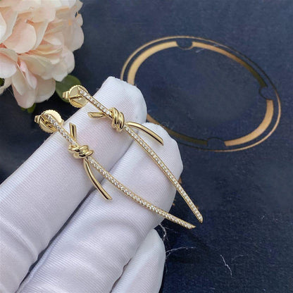 {
  "Resenly Jewelry": "Resenly Jewelry",
  "KNOT DROP EARRINGS IN YELLOW GOLD WITH DIAMONDS": "ノット ドロップ イヤリング（イエローゴールド、ダイヤモンド）"
}